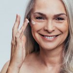 A woman applies blepharogel for wrinkles