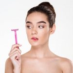 Girl holding a razor in her hand